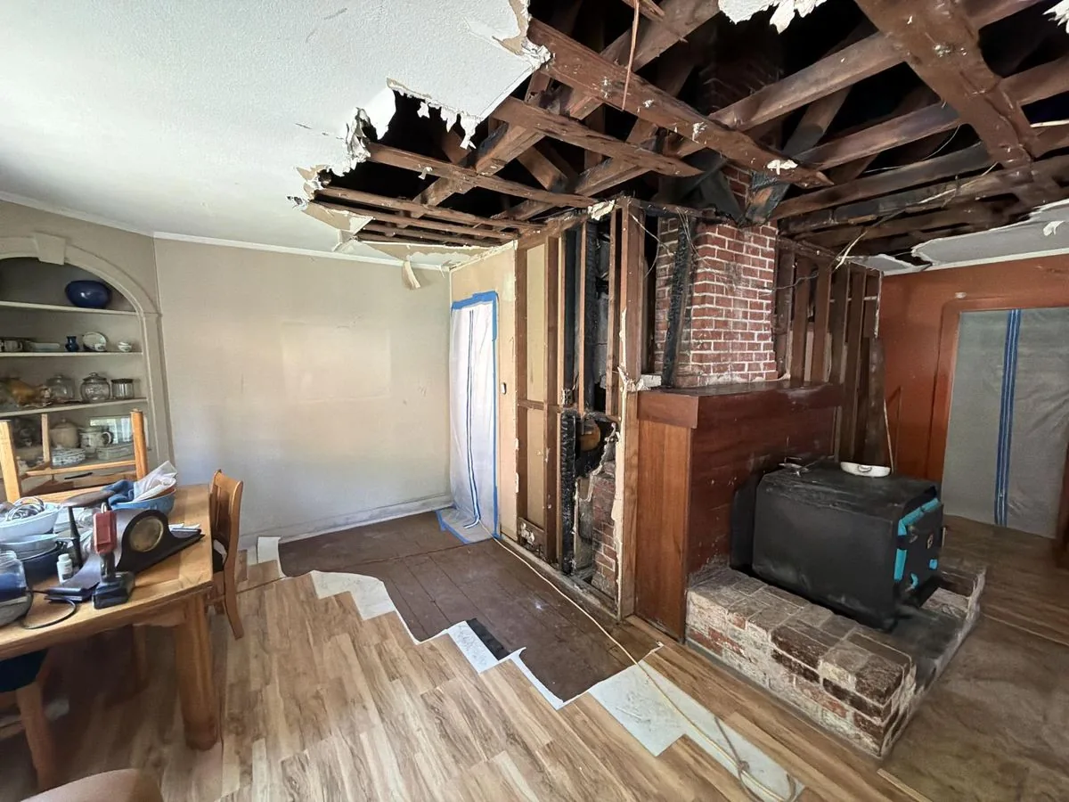 Chimney fire damage cleanup in Fort Bragg — charred framing exposed and containment set by North Coast Restoration