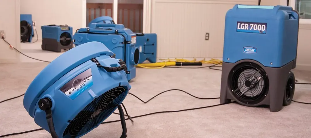 Air movers and a dehumidifier running during structural drying on a Mendocino County job
